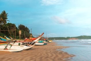 Fishing wooden boats by the ocean,Fishing boat in Sri Lanka,Fishing boats parked on the sand, fishin
